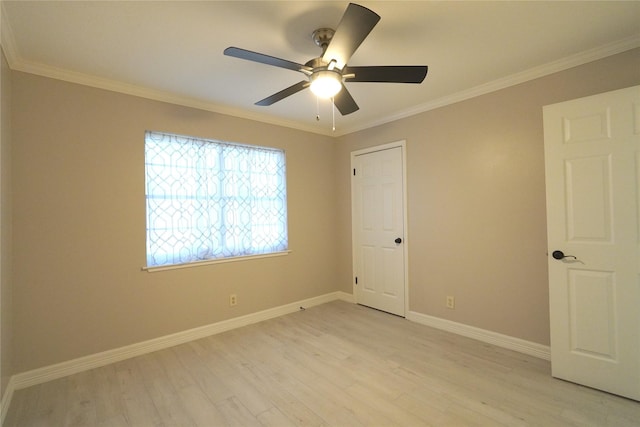 unfurnished room featuring crown molding, light wood-type flooring, and baseboards