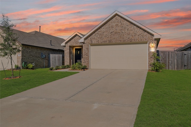 view of front of property with a garage and a yard