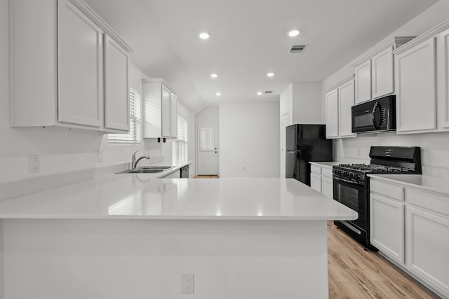 kitchen featuring light wood-type flooring, black appliances, white cabinetry, and sink