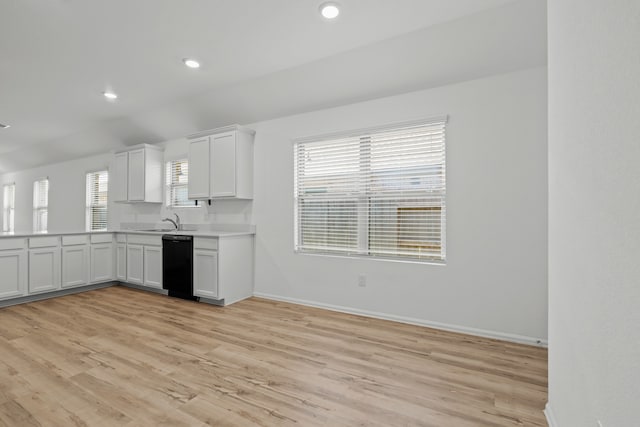 kitchen featuring dishwasher, light hardwood / wood-style floors, white cabinetry, and sink