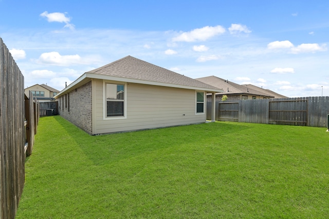 rear view of property with a lawn