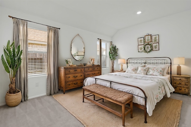 bedroom featuring light carpet and lofted ceiling