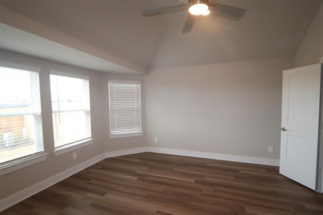 empty room with ceiling fan, vaulted ceiling, and dark hardwood / wood-style flooring