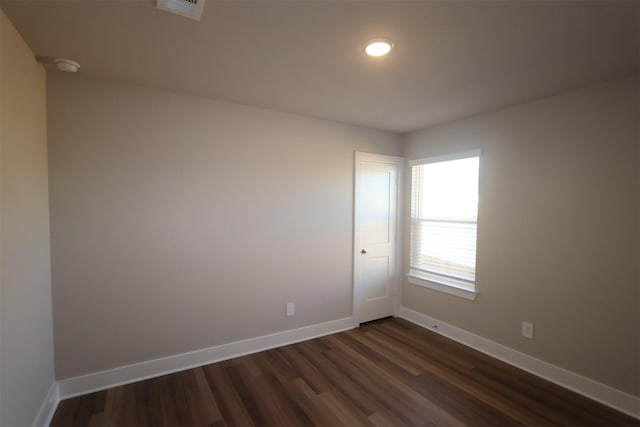 unfurnished room featuring dark hardwood / wood-style floors