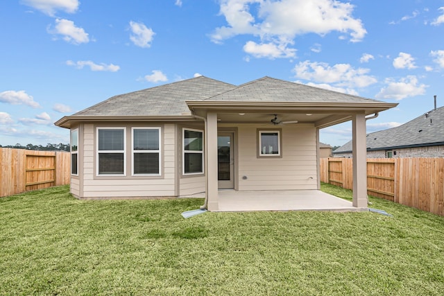 rear view of property featuring a yard, ceiling fan, a fenced backyard, and a patio