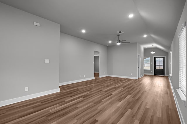 unfurnished living room featuring baseboards, visible vents, ceiling fan, and wood finished floors