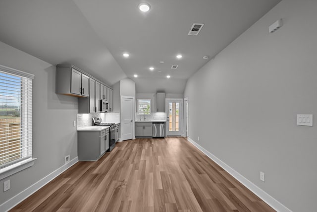 kitchen with visible vents, decorative backsplash, appliances with stainless steel finishes, light countertops, and gray cabinetry