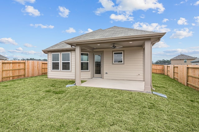 rear view of property featuring a fenced backyard, a patio, a ceiling fan, and a yard