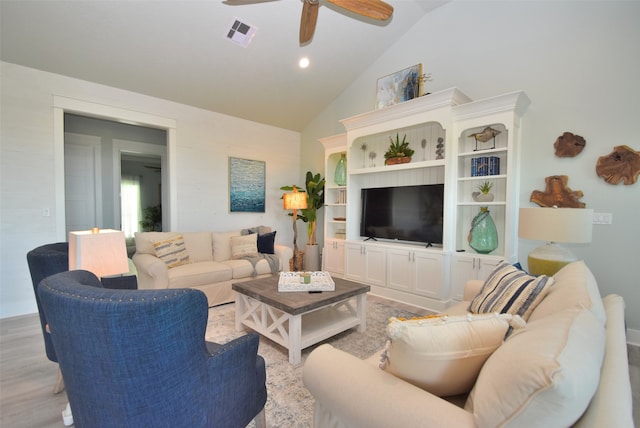 living room with light hardwood / wood-style floors, high vaulted ceiling, and ceiling fan