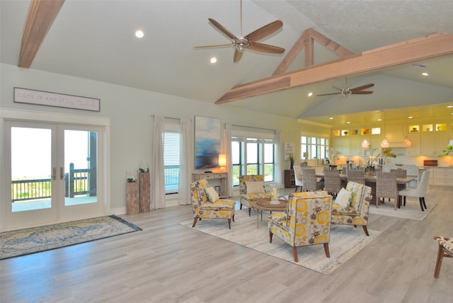 living room with beamed ceiling, french doors, light wood-type flooring, high vaulted ceiling, and ceiling fan