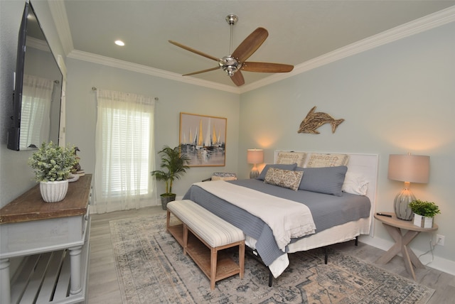 bedroom featuring crown molding, hardwood / wood-style floors, and ceiling fan