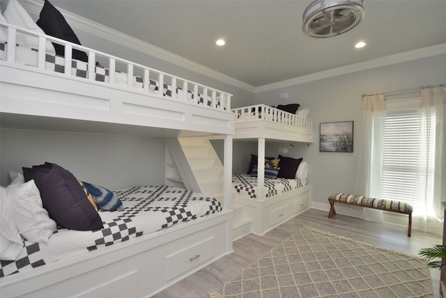 bedroom with ornamental molding and light wood-type flooring