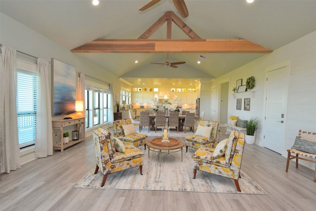 living room with vaulted ceiling with beams, ceiling fan, and light hardwood / wood-style floors