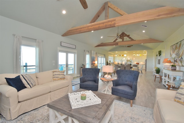 living room featuring high vaulted ceiling, beamed ceiling, ceiling fan, and light hardwood / wood-style floors