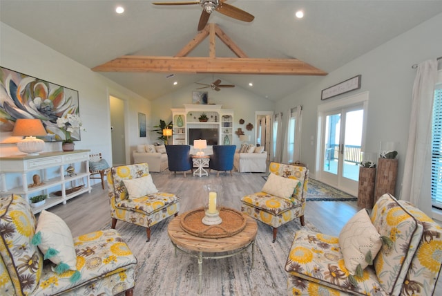 living room featuring vaulted ceiling with beams, ceiling fan, and light hardwood / wood-style floors