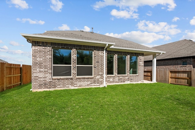 back of house with a lawn