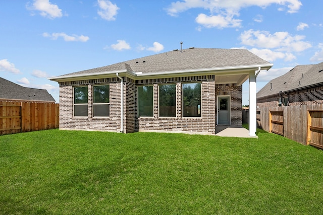 back of property with a patio area and a lawn