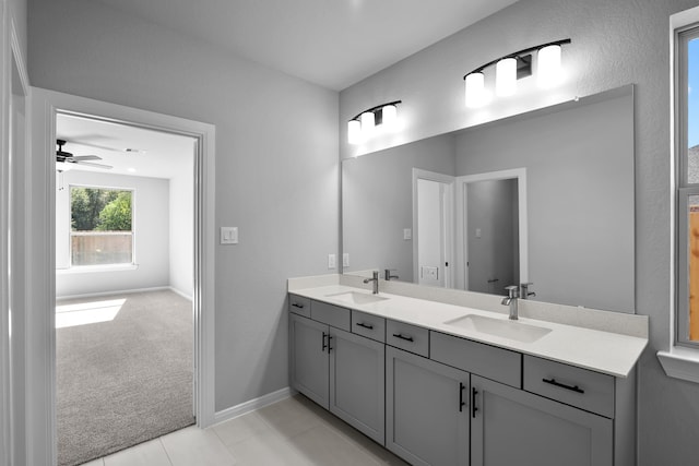 bathroom with ceiling fan, tile patterned flooring, and vanity