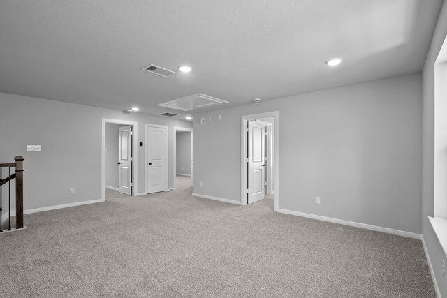 spare room featuring light colored carpet