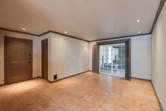 unfurnished room featuring ornamental molding and light tile patterned floors