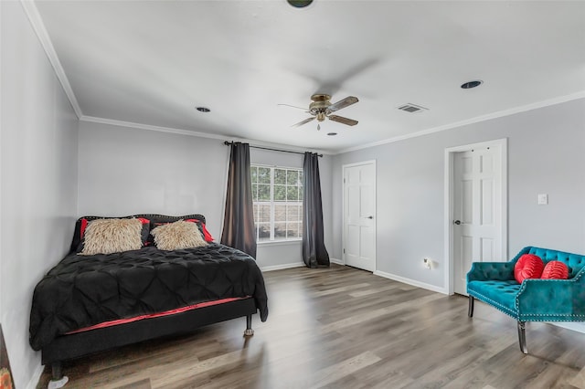 bedroom featuring wood-type flooring, ceiling fan, and ornamental molding