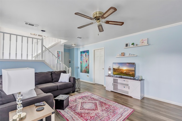 living room featuring wood-type flooring, ceiling fan, and crown molding