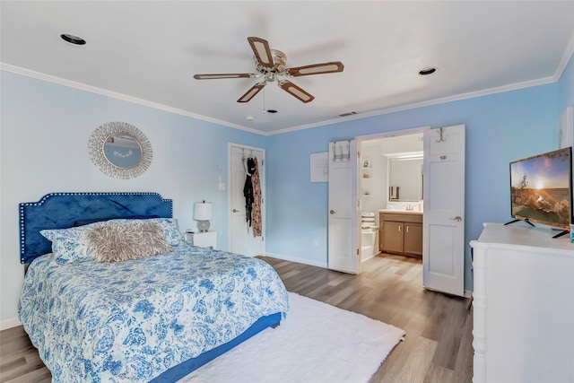 bedroom with wood-type flooring, connected bathroom, ceiling fan, and crown molding