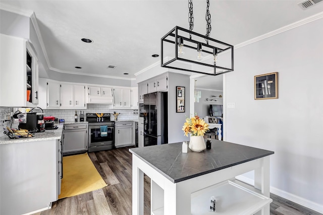 kitchen featuring tasteful backsplash, dark hardwood / wood-style flooring, premium range hood, appliances with stainless steel finishes, and ornamental molding