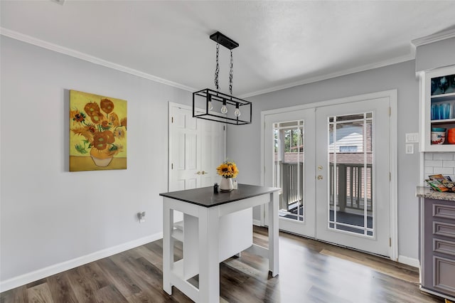 dining room featuring dark hardwood / wood-style floors, ornamental molding, and french doors