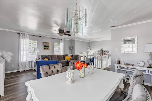 dining area featuring an inviting chandelier, crown molding, and dark wood-type flooring