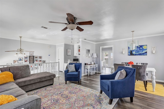 living room featuring dark hardwood / wood-style floors, ceiling fan, and ornamental molding