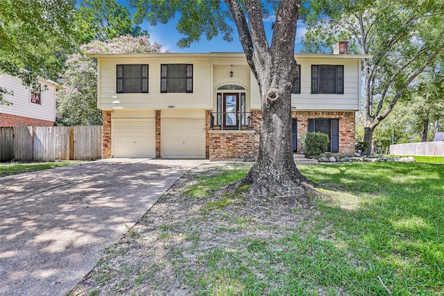 bi-level home with a garage and a front yard