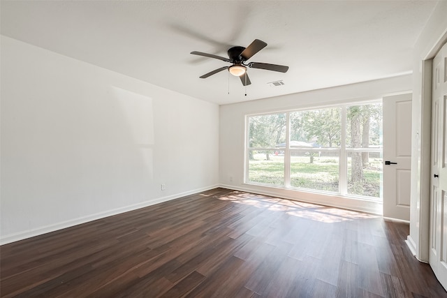 spare room featuring ceiling fan and dark hardwood / wood-style flooring