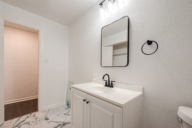 bathroom with wood-type flooring, vanity, and toilet