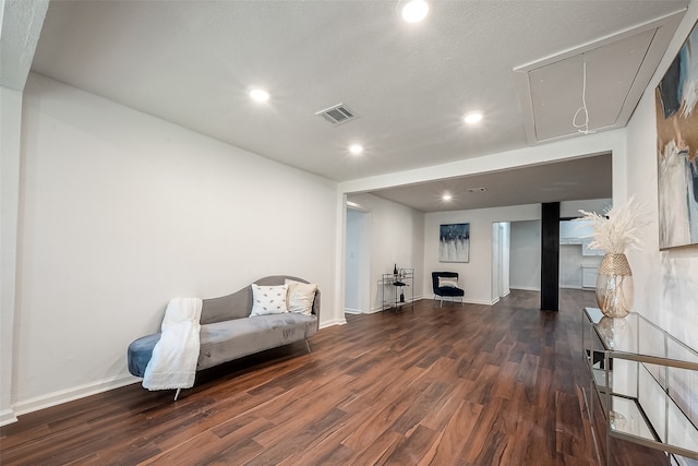 sitting room with a textured ceiling and dark hardwood / wood-style floors