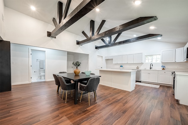 dining room featuring beam ceiling, dark wood-type flooring, and sink