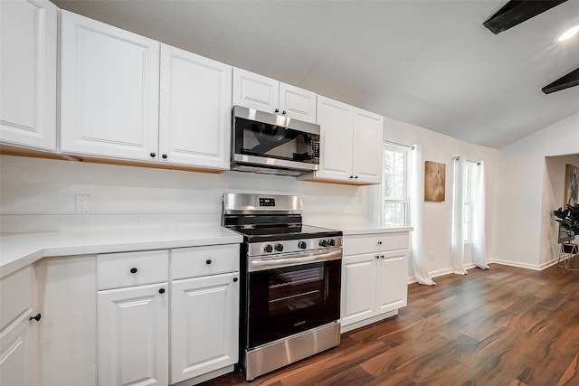 kitchen with vaulted ceiling, dark hardwood / wood-style flooring, stainless steel appliances, and white cabinets