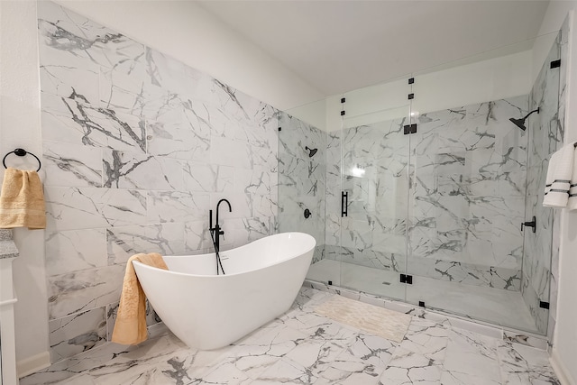 bathroom with tile walls and independent shower and bath