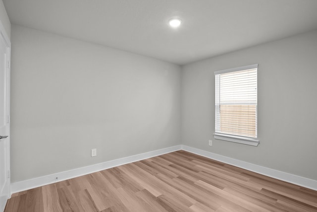 empty room with light wood-type flooring and baseboards