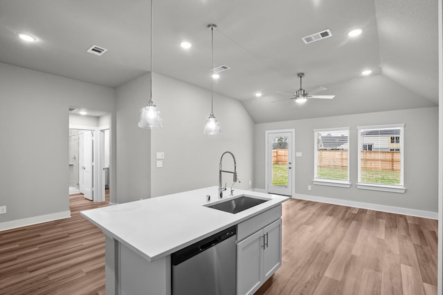 kitchen featuring light countertops, visible vents, dishwasher, and a sink