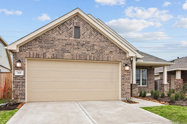 view of front of house with a shingled roof, brick siding, driveway, and an attached garage