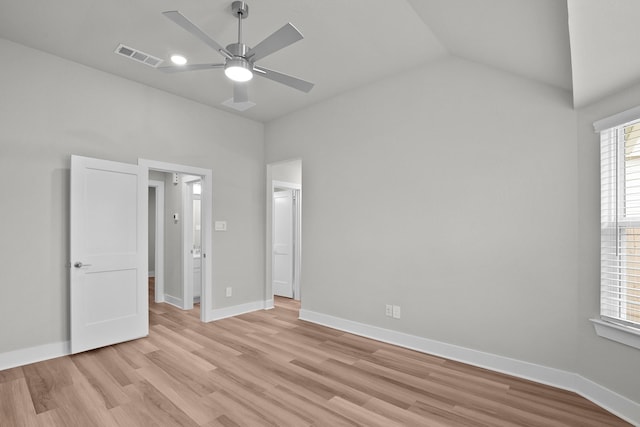 unfurnished bedroom featuring lofted ceiling, visible vents, light wood-style floors, ceiling fan, and baseboards