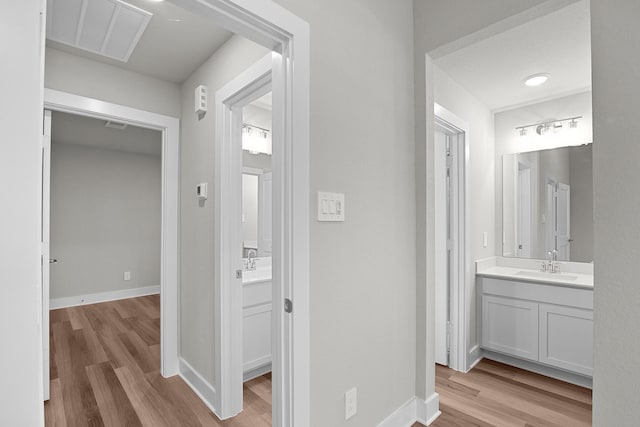 bathroom with visible vents, baseboards, and wood finished floors