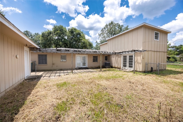 rear view of property with central AC, french doors, and a yard