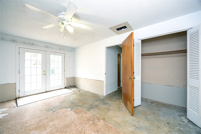 unfurnished bedroom featuring a textured ceiling, french doors, a closet, and ceiling fan