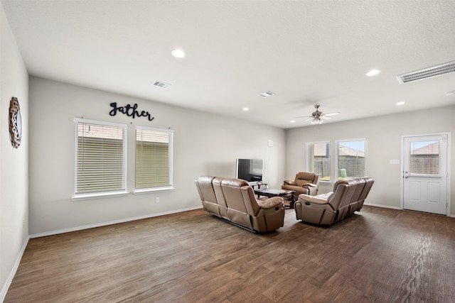 living room with ceiling fan and hardwood / wood-style floors