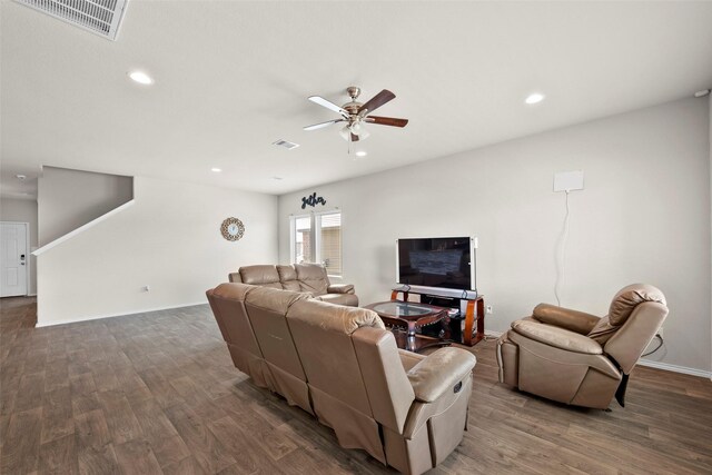 living room featuring dark hardwood / wood-style flooring and ceiling fan