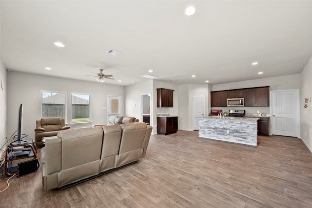 living room with ceiling fan and light wood-type flooring