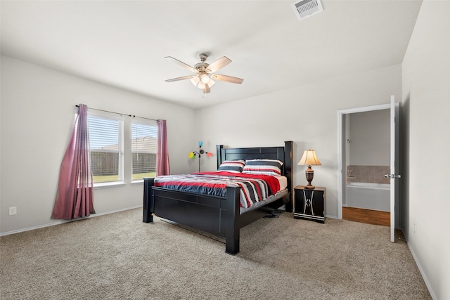 carpeted bedroom featuring ensuite bath and ceiling fan