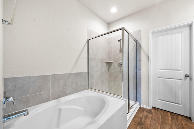 bathroom with plus walk in shower and hardwood / wood-style floors